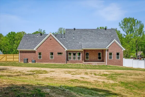 a front view of a house with a garden and yard