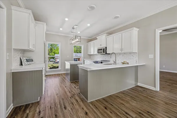 a kitchen with stainless steel appliances a refrigerator sink and cabinets