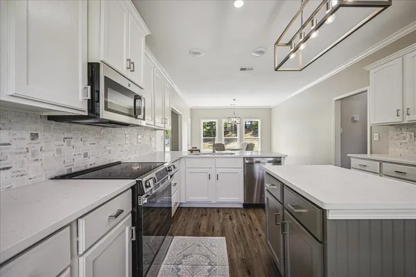 a kitchen with a sink stove and cabinets