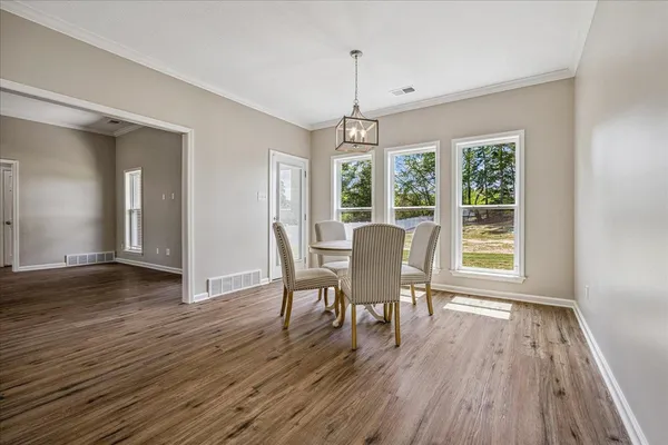a view of a dining room with furniture windows and wooden floor