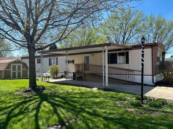 a view of a house with a yard and a patio