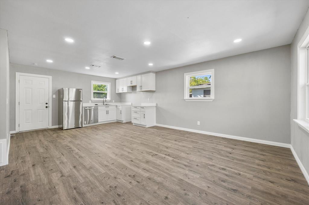 445 Canal Street Quinlan, TX 75474 - Photo 2 of 23 a view of an empty room with wooden floor