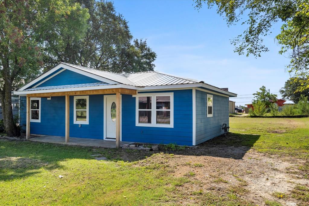 445 Canal Street Quinlan, TX 75474 - Photo 6 of 23 a front view of a house with garden