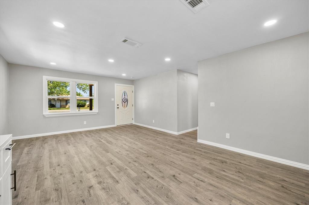 445 Canal Street Quinlan, TX 75474 - Photo 9 of 23 an empty room with wooden floor and windows