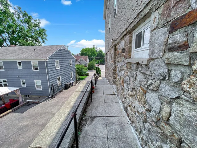 a view of a pathway both side of house