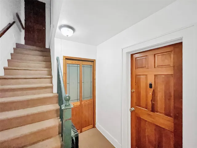 a view of entryway with wooden floor and door