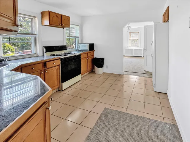 a kitchen with stainless steel appliances a stove a sink and a microwave
