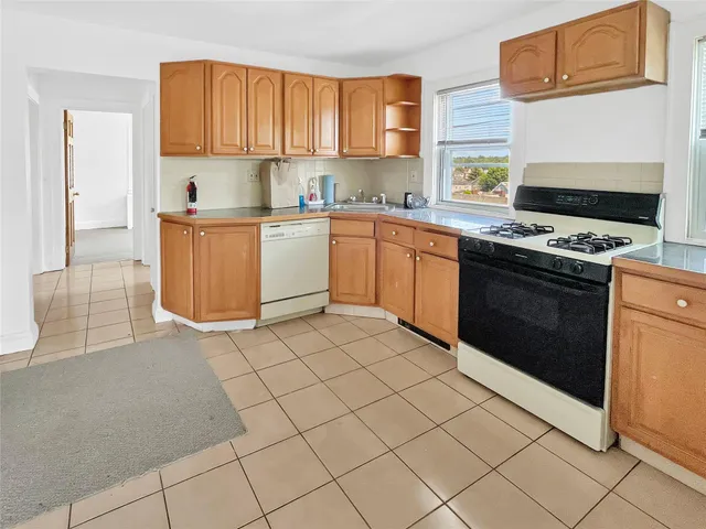 a kitchen with a stove a sink and a refrigerator