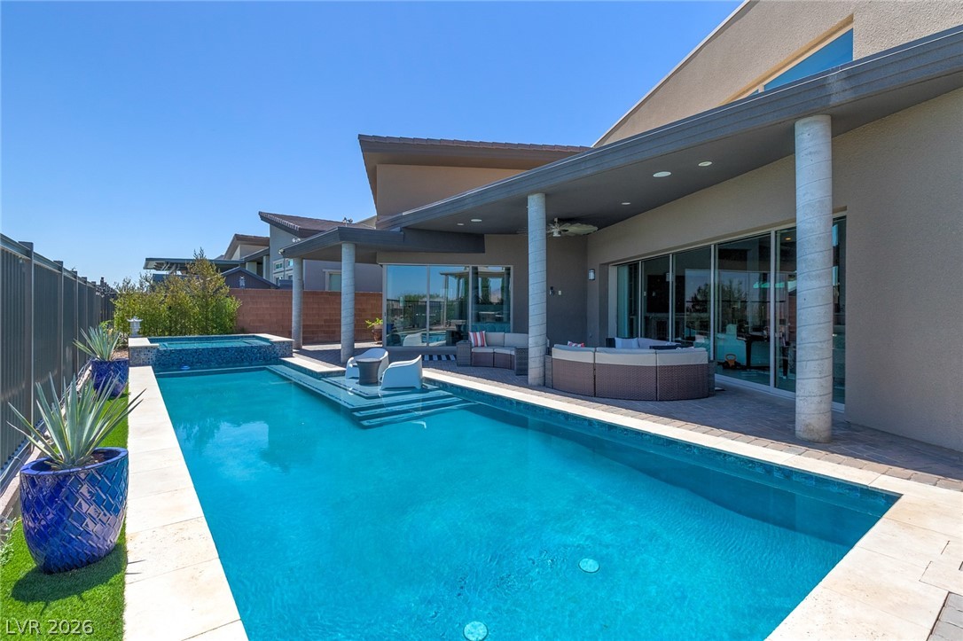 6014 Willow Ridge Court Las Vegas, NV 89135 - Photo 65 of 99 An inviting backyard oasis features a shimmering pool, spa, and covered patio for relaxation.