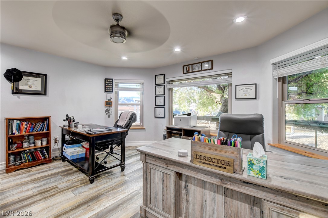 6460 Racel Street Las Vegas, NV 89131 - Photo 51 of 59 Recessed lighting and rustic wood-look flooring enhance this light-filled workspace with generous window views.