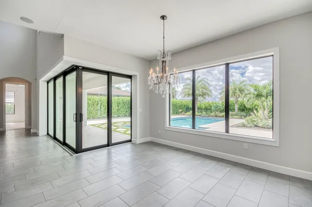 a view of a living room with a painting on the wall and a window