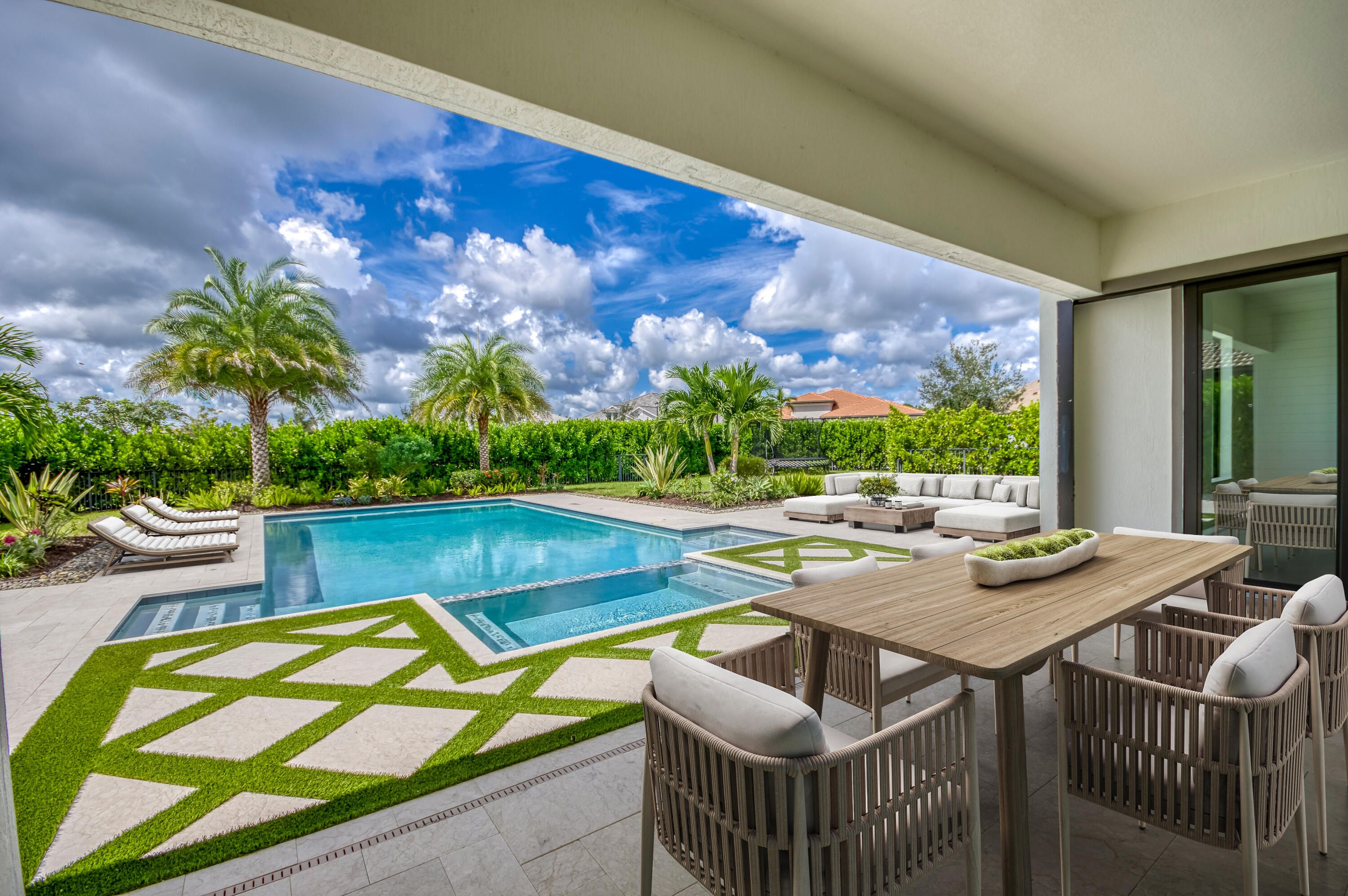 102 Cerulean Key Way Jupiter, FL 33478 - Photo 21 of 85 a view of a patio with swimming pool and sitting area