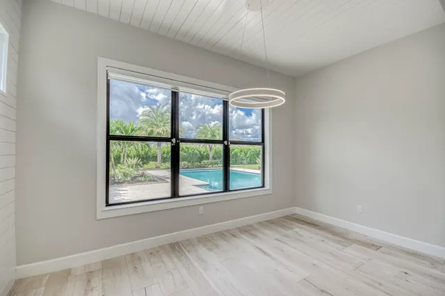 a bathroom with a granite countertop sink a toilet and a mirror