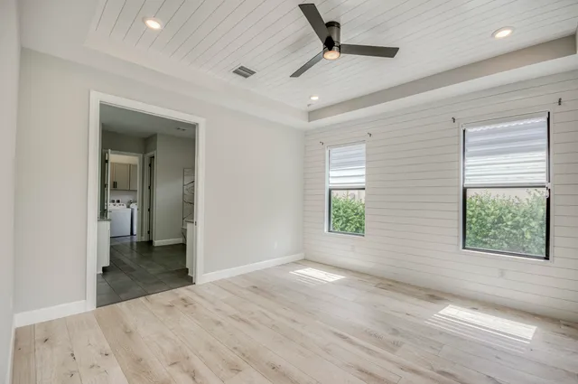 an empty room with windows and closet