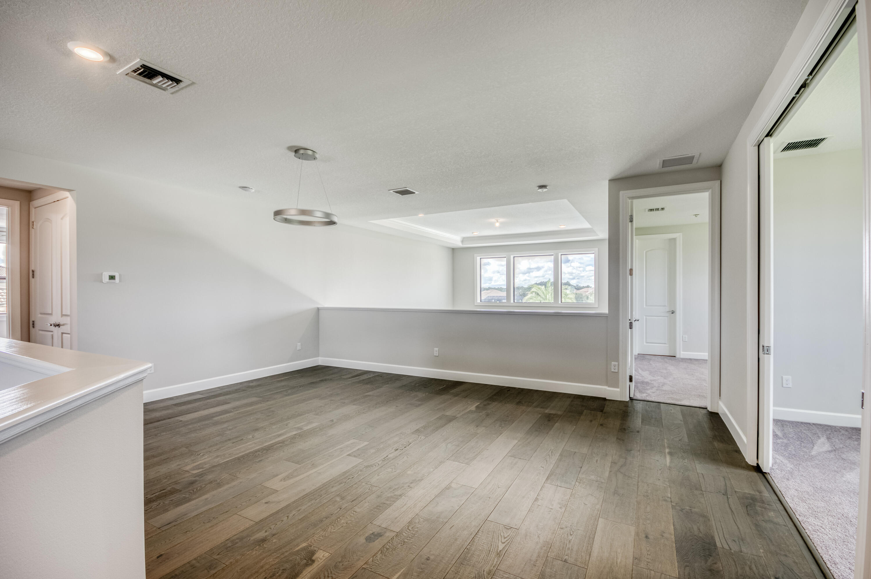 102 Cerulean Key Way Jupiter, FL 33478 - Photo 46 of 85 an empty room with wooden floor and windows
