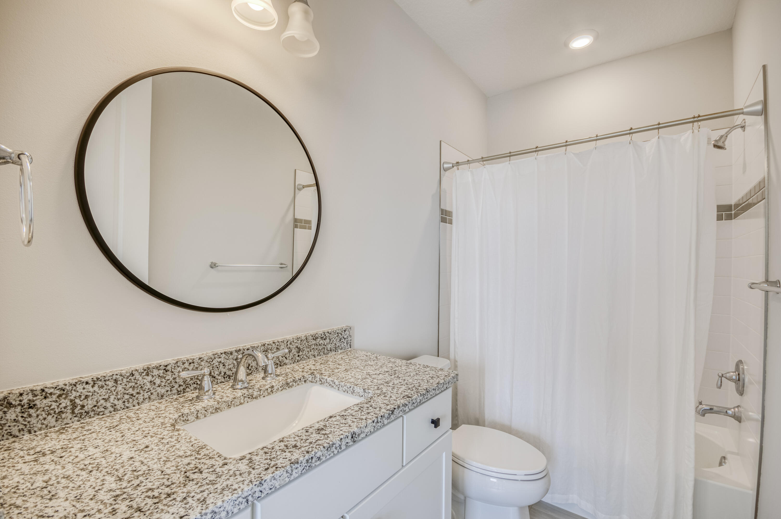 102 Cerulean Key Way Jupiter, FL 33478 - Photo 52 of 85 a bathroom with a granite countertop sink a toilet and a mirror