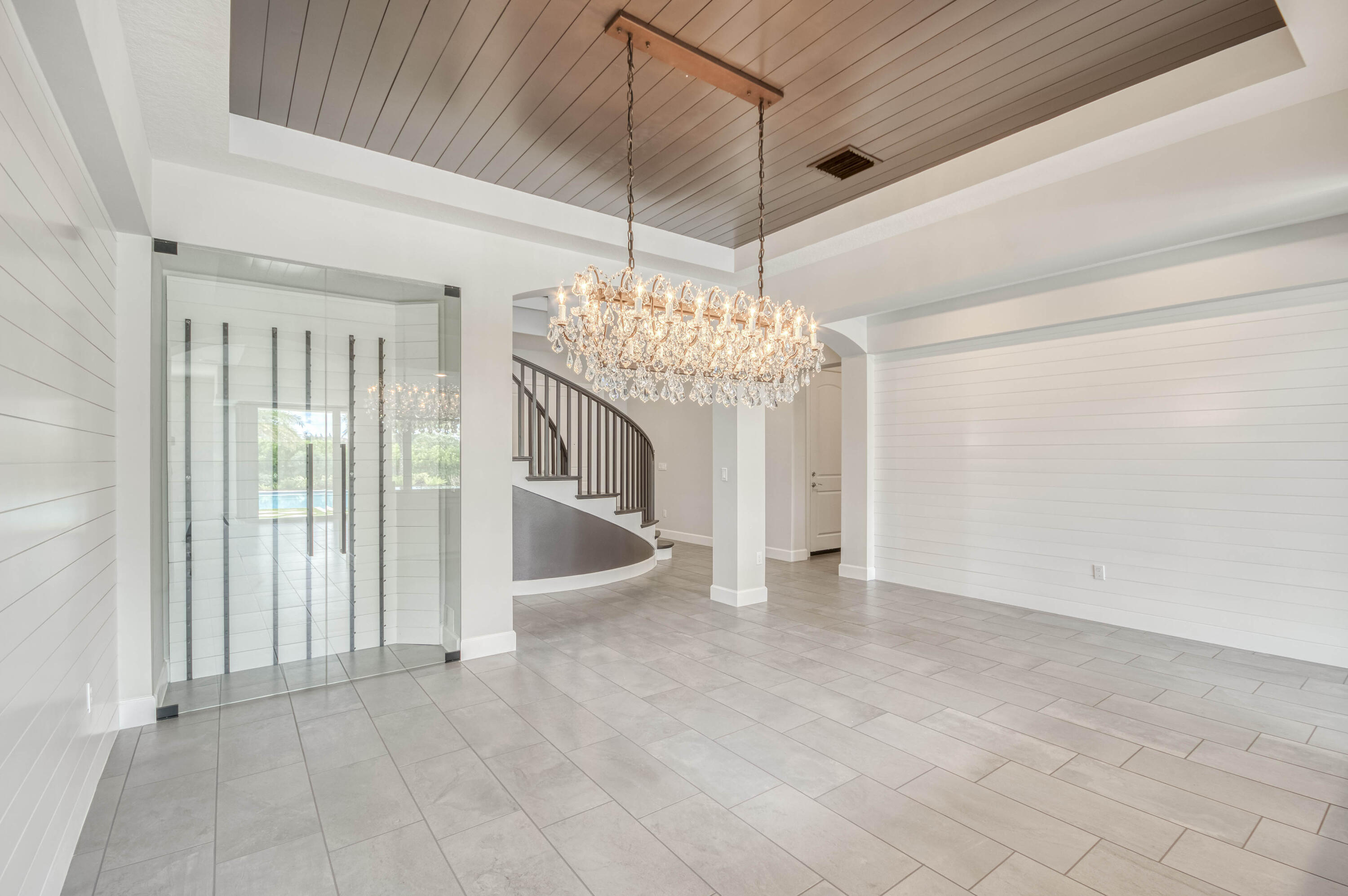 102 Cerulean Key Way Jupiter, FL 33478 - Photo 6 of 85 a view of a livingroom with a chandelier fan and kitchen view