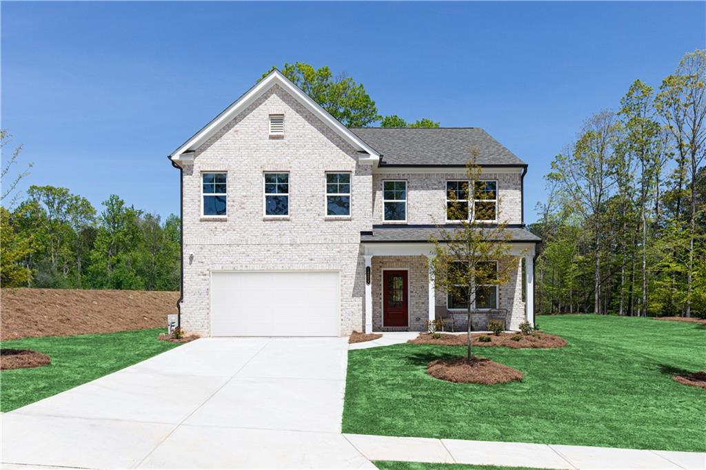 3260 Croftside Commons Powder Springs, GA 30127 - Photo 2 of 64 a view of a white house with a yard potted plants and a table and chair