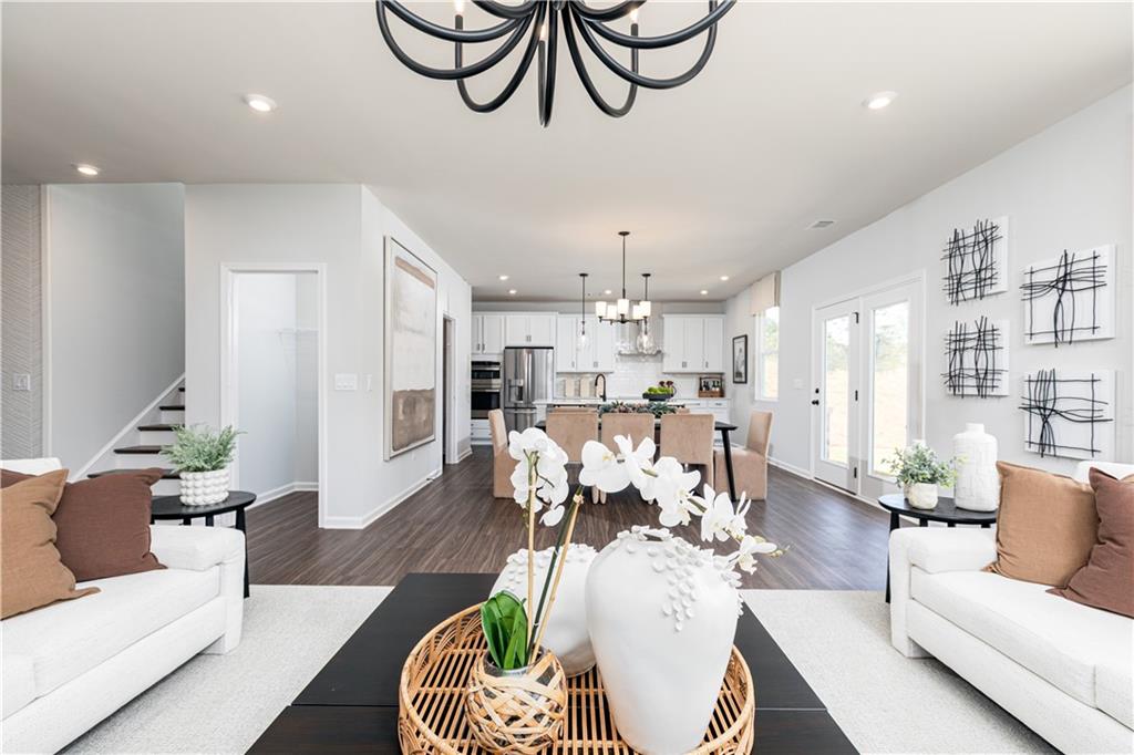 3260 Croftside Commons Powder Springs, GA 30127 - Photo 22 of 64 a living room with furniture kitchen view and a chandelier