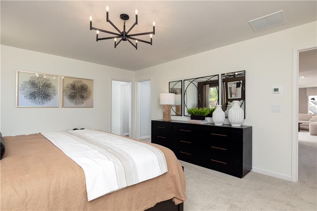 3260 Croftside Commons Powder Springs, GA 30127 - Photo 29 of 64 a bedroom with a bed and a chandelier