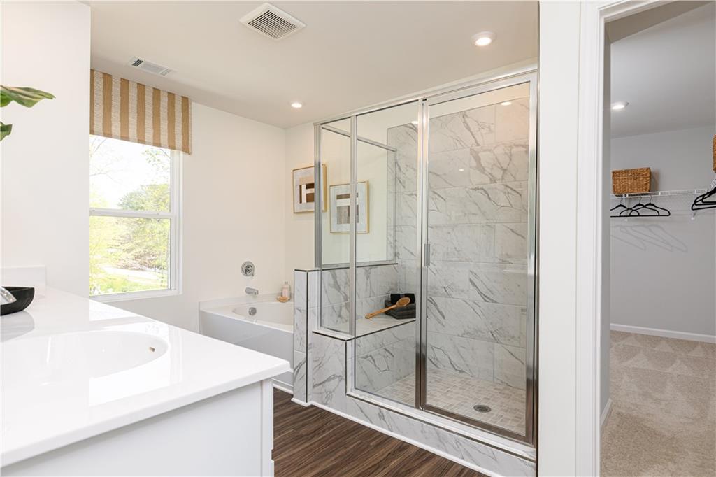 3260 Croftside Commons Powder Springs, GA 30127 - Photo 30 of 64 a bathroom with a shower a sink and a bathtub