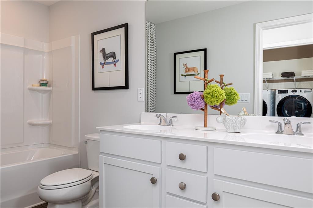 3260 Croftside Commons Powder Springs, GA 30127 - Photo 37 of 64 a bathroom with a granite countertop sink mirror vanity and toilet