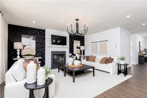 a living room with furniture a fireplace and a flat screen tv