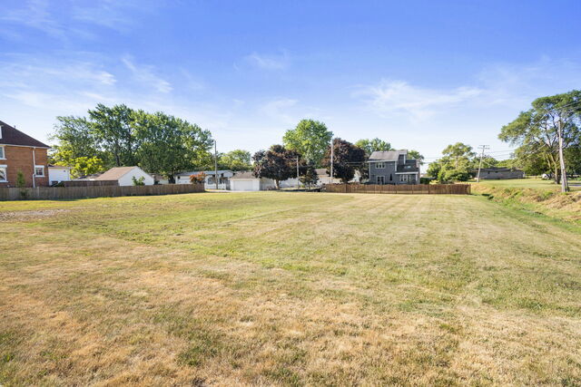 652 Penfield Street Beecher, IL 60401 - Photo 2 of 16 a view of a swimming pool and trees in the background