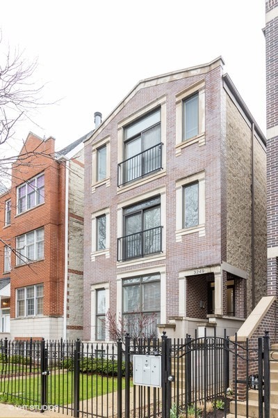 a front view of a brick building with many windows