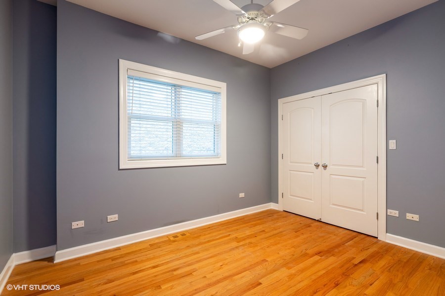 3249 North Racine Avenue, Unit 2 Chicago, IL 60657 - Photo 7 of 10 a view of a room with a ceiling fan and wooden floor