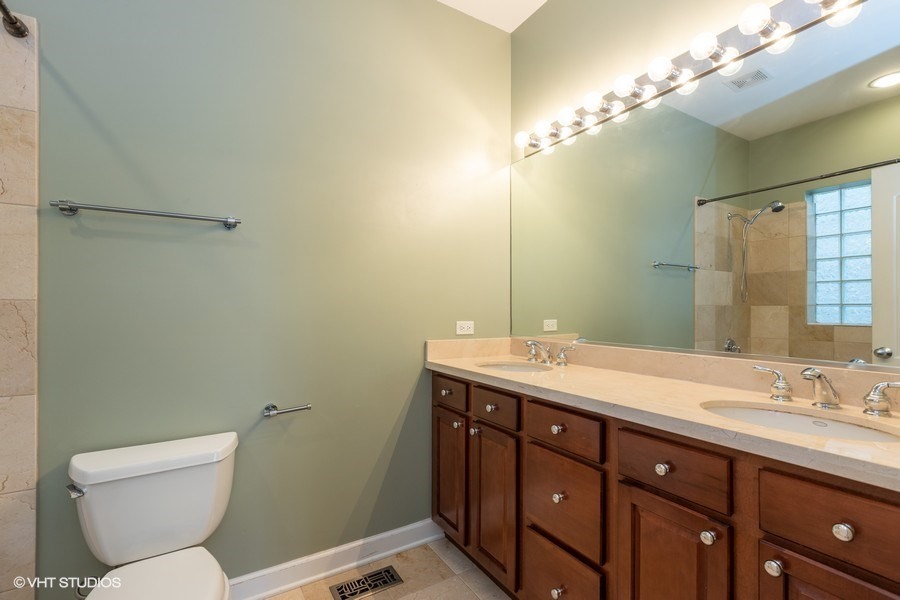 3249 North Racine Avenue, Unit 2 Chicago, IL 60657 - Photo 8 of 10 a bathroom with a toilet sink and mirror