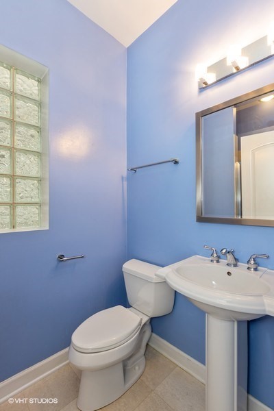 3249 North Racine Avenue, Unit 2 Chicago, IL 60657 - Photo 9 of 10 a bathroom with a sink mirror and toilet