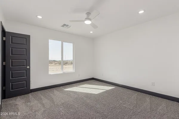 an empty room with windows and closet
