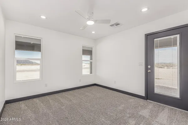 an empty room with windows and closet