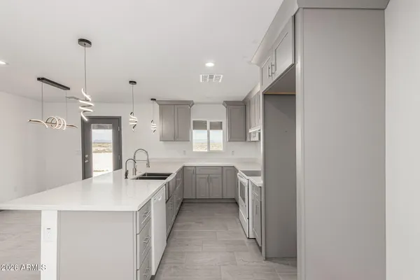 a kitchen with kitchen island a sink stainless steel appliances and cabinets