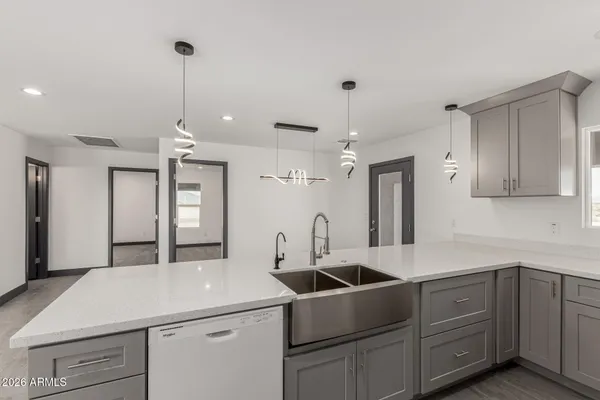 a kitchen with a sink appliances and cabinets