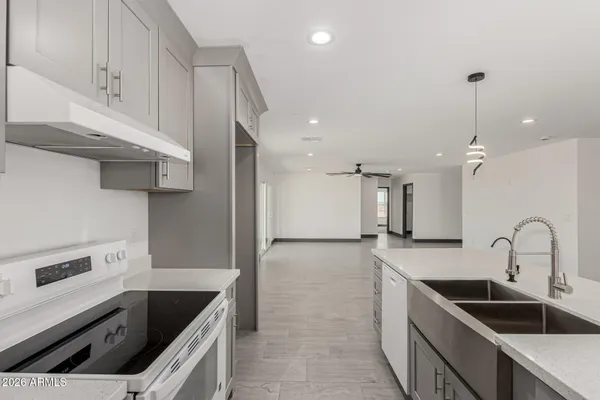 a kitchen with stainless steel appliances granite countertop a sink and cabinets