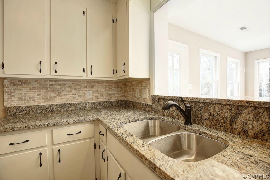 6600 Rock Run Road Chesterfield, VA 23832 - Photo 10 of 24 a kitchen with granite countertop a sink window and white cabinets