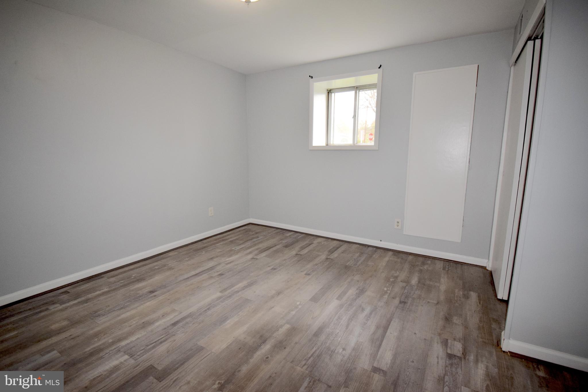 14017 Adkins Road Laurel, MD 20708 - Photo 12 of 19 an empty room with wooden floor and windows