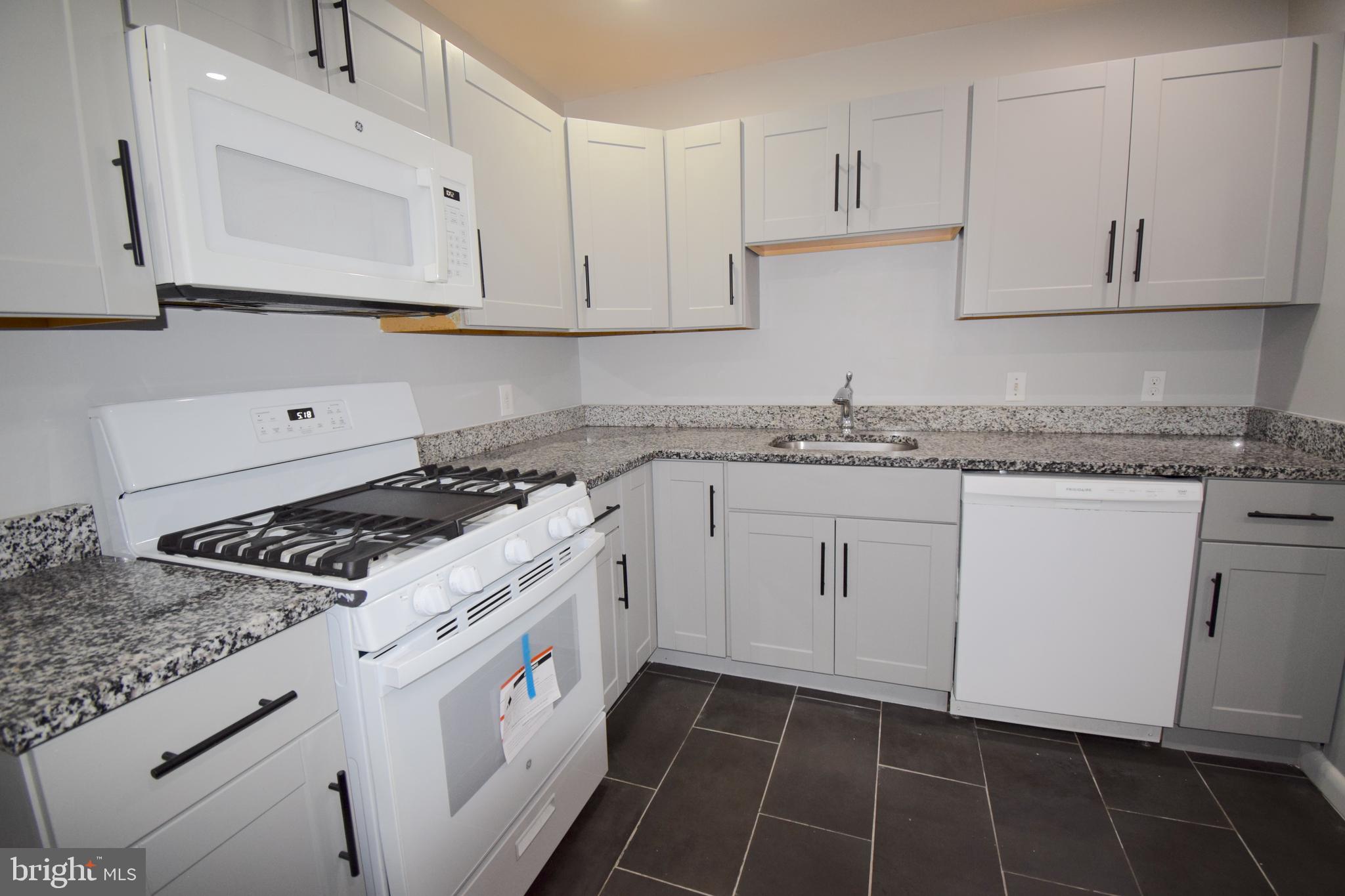 14017 Adkins Road Laurel, MD 20708 - Photo 10 of 19 a kitchen with granite countertop white cabinets white stainless steel appliances and a sink