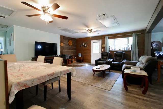 a kitchen view with living room furniture and a ceiling fan