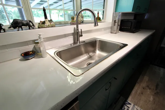 a kitchen with cabinets and a stainless steel refrigerator