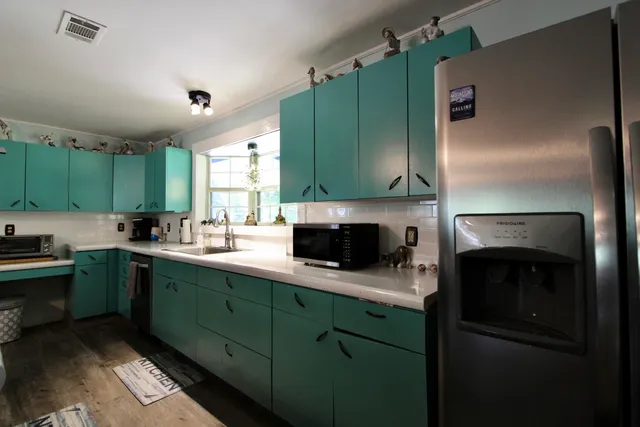 a kitchen with a stove and a refrigerator
