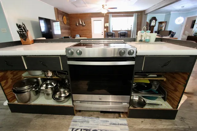 a kitchen with a refrigerator and a stove