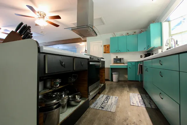 a kitchen with stainless steel appliances granite countertop a refrigerator a stove a sink dishwasher and a refrigerator