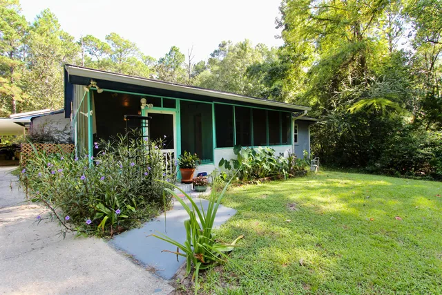 a front view of house with garden and porch