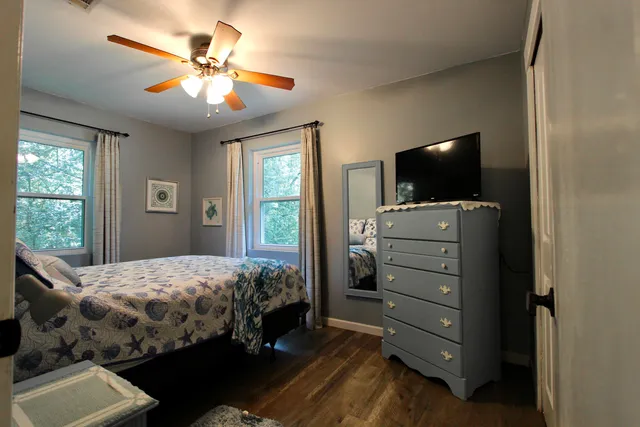 a bedroom with a bed and a chandelier