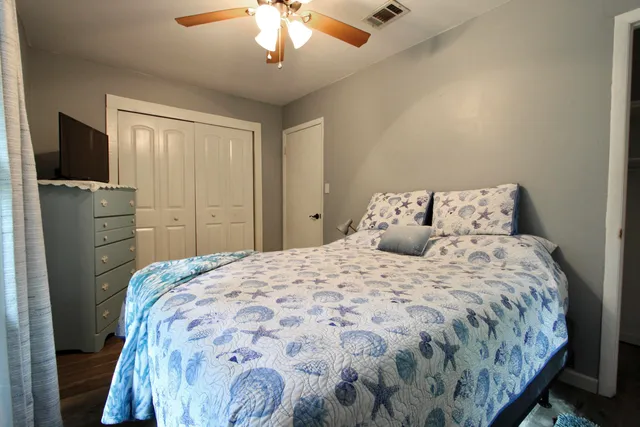 a living room with furniture a wooden floor and a chandelier