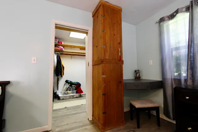 a wooden deck with a yard and wooden fence