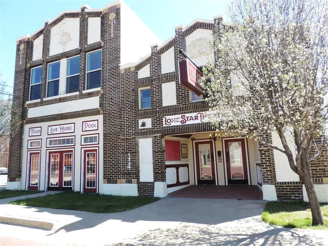 a view of a building with a yard